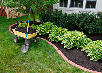 applying mulch on a lawn